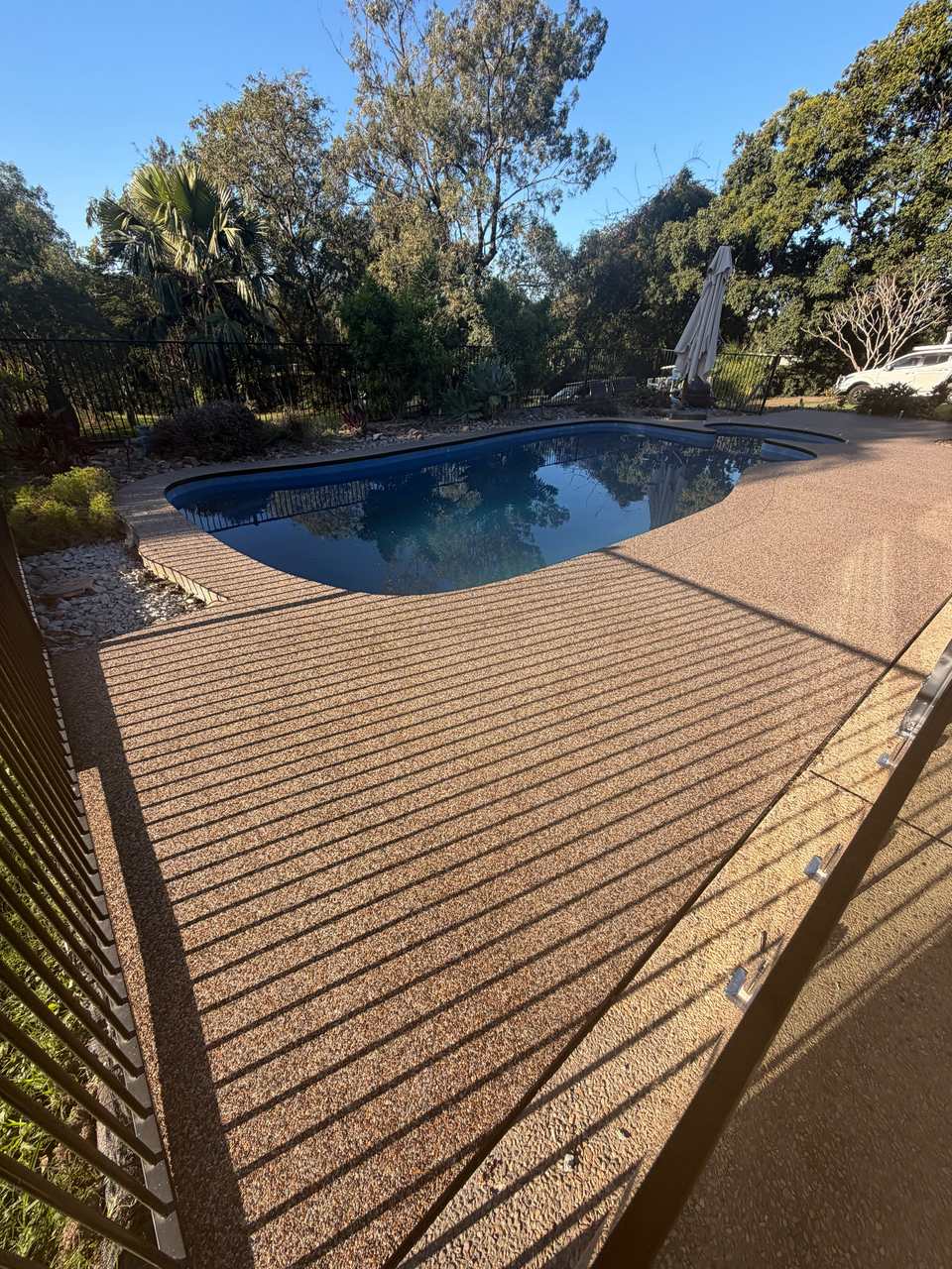 Warm tan resin pool surround Gold Coast